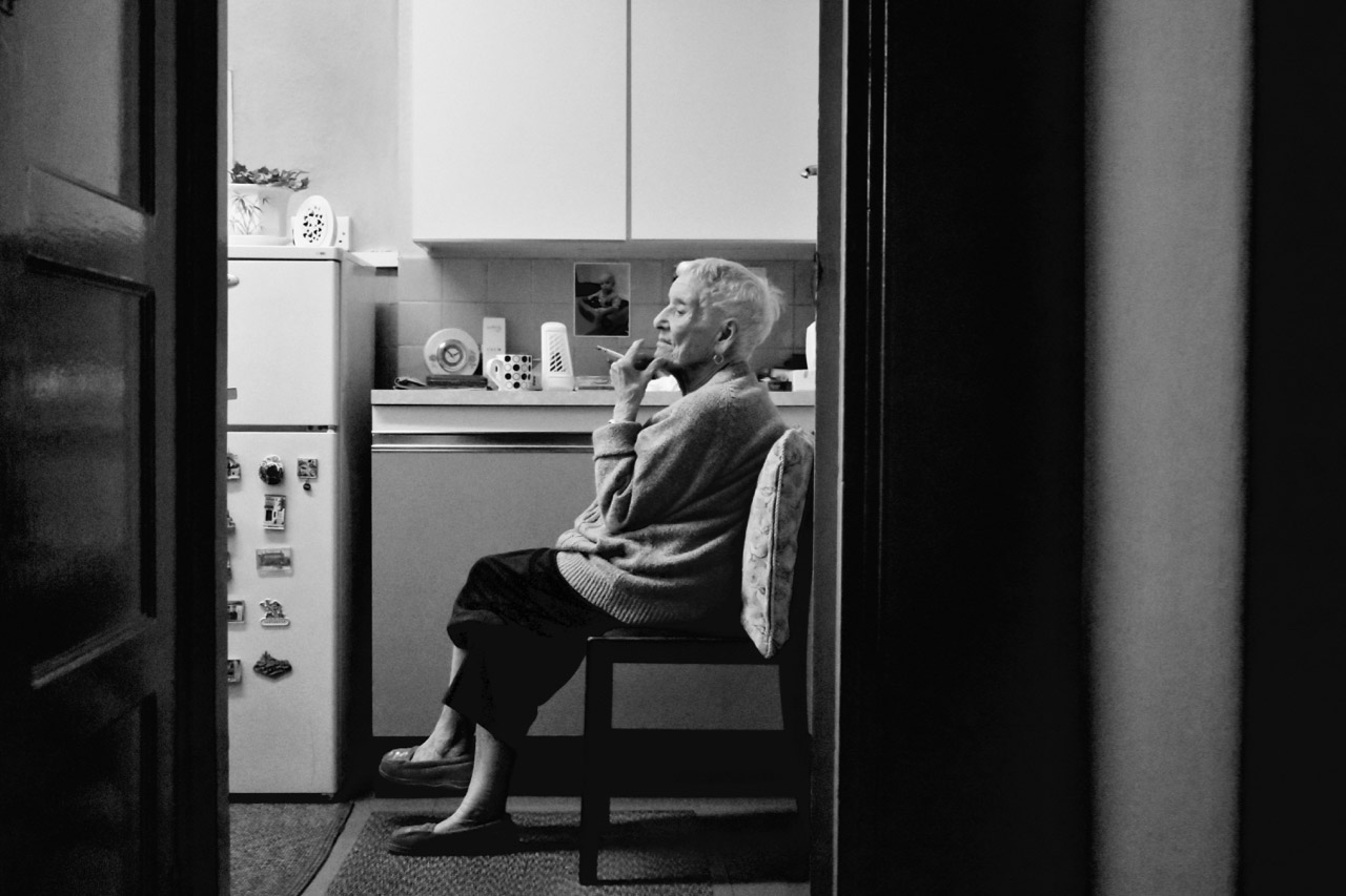 Nan sat in kitchen, colour.