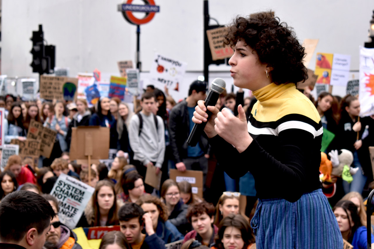 Woman speaking to crowd with microphone