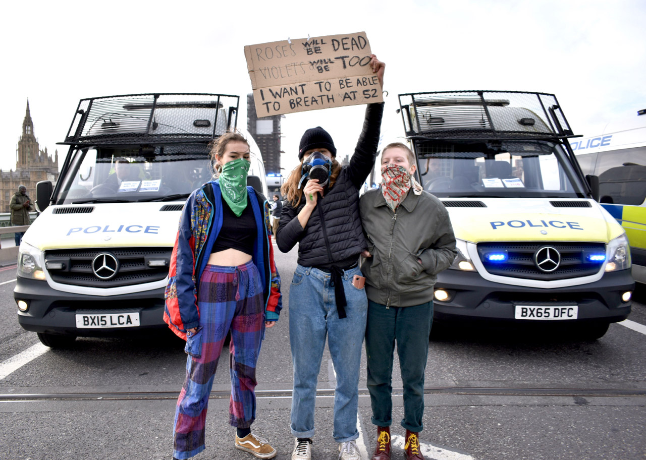 Protest XR Group with Sign in front of police van.