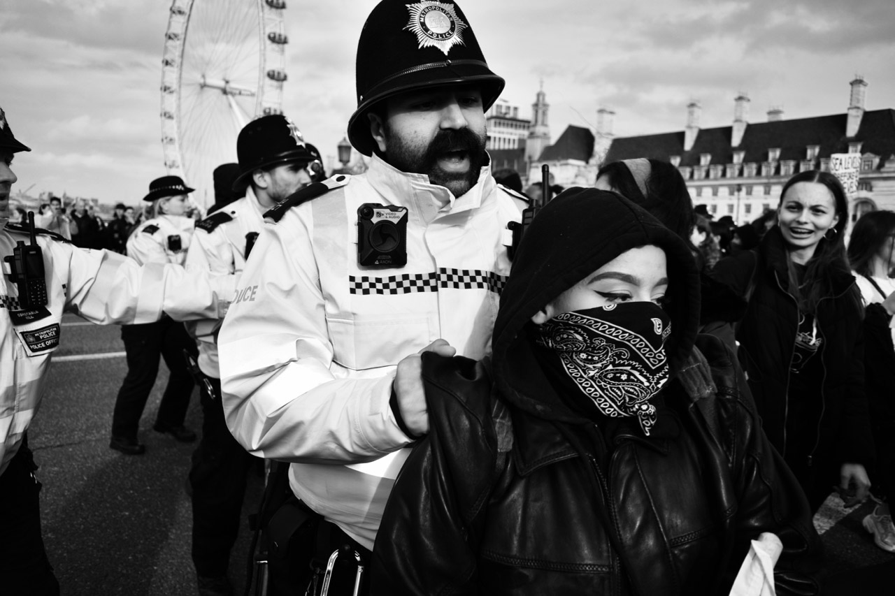 Protest Protestor with mask and policeman.