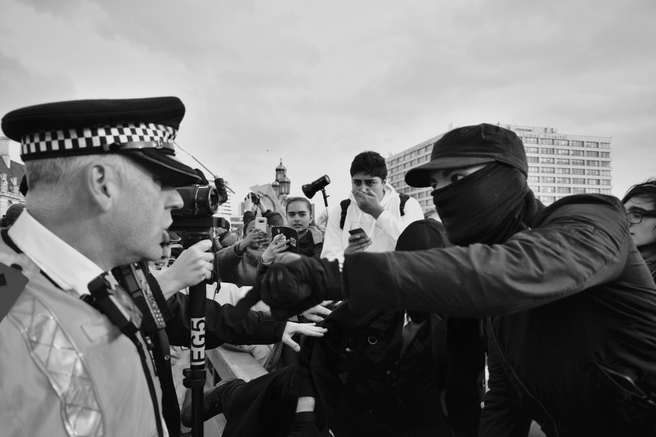 Protest Protestor pointing at policeman.