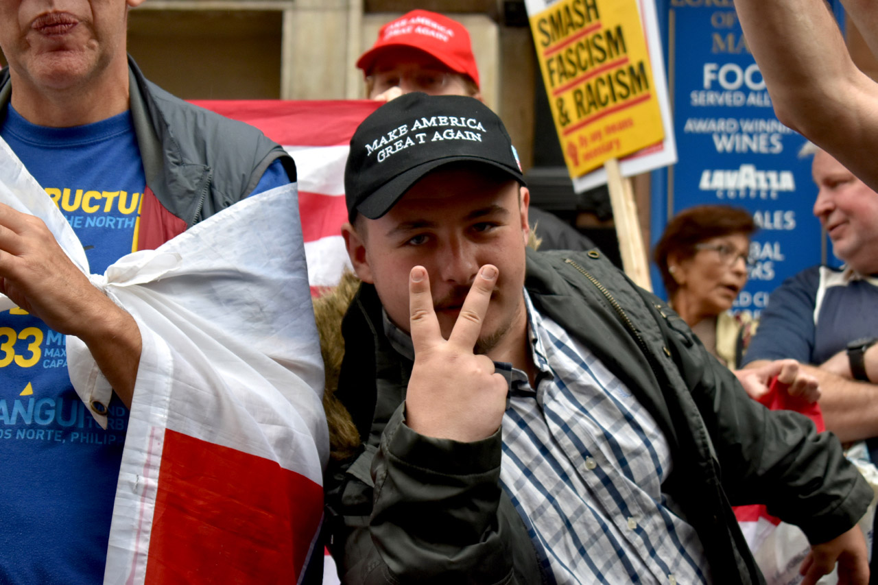 Protest Trump fan giving fingers.