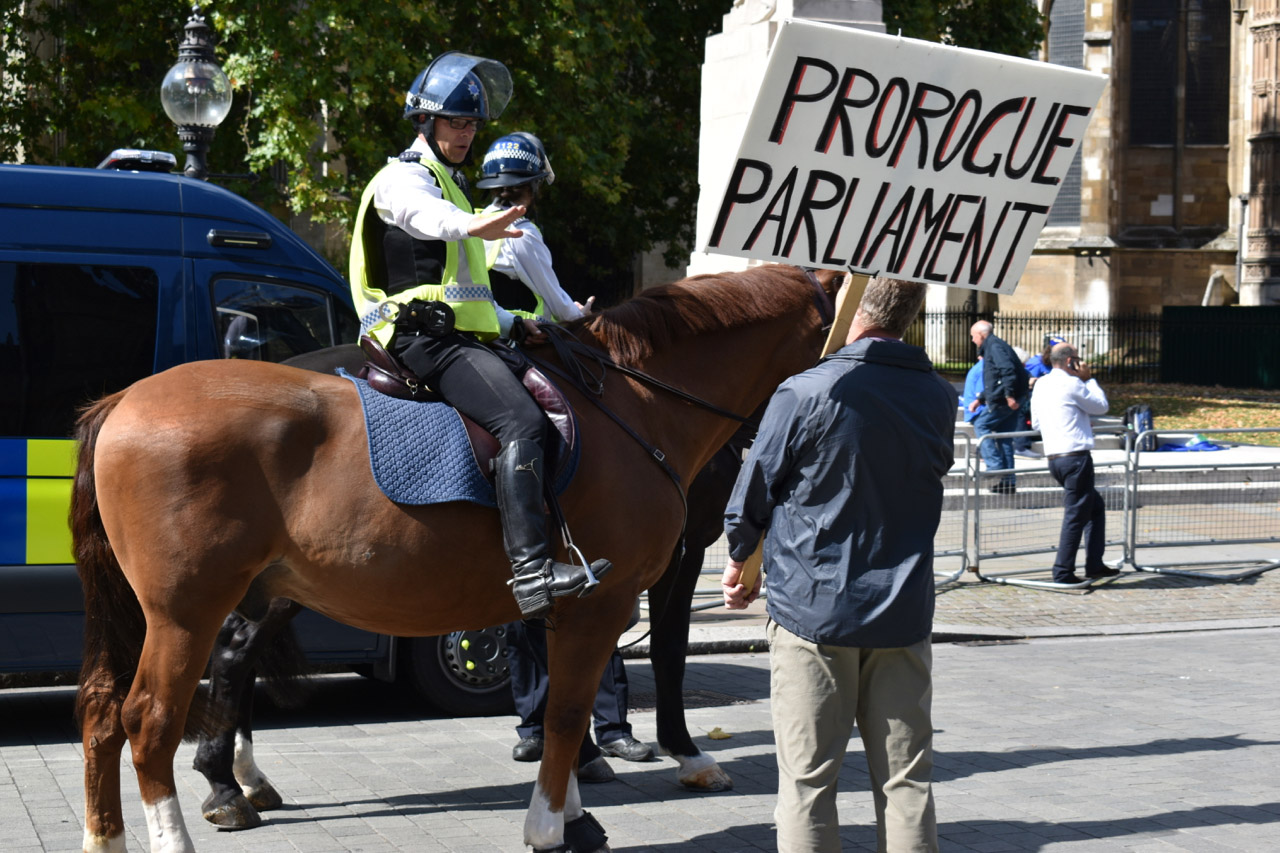 Protest man holding Prorogue Parliament sign