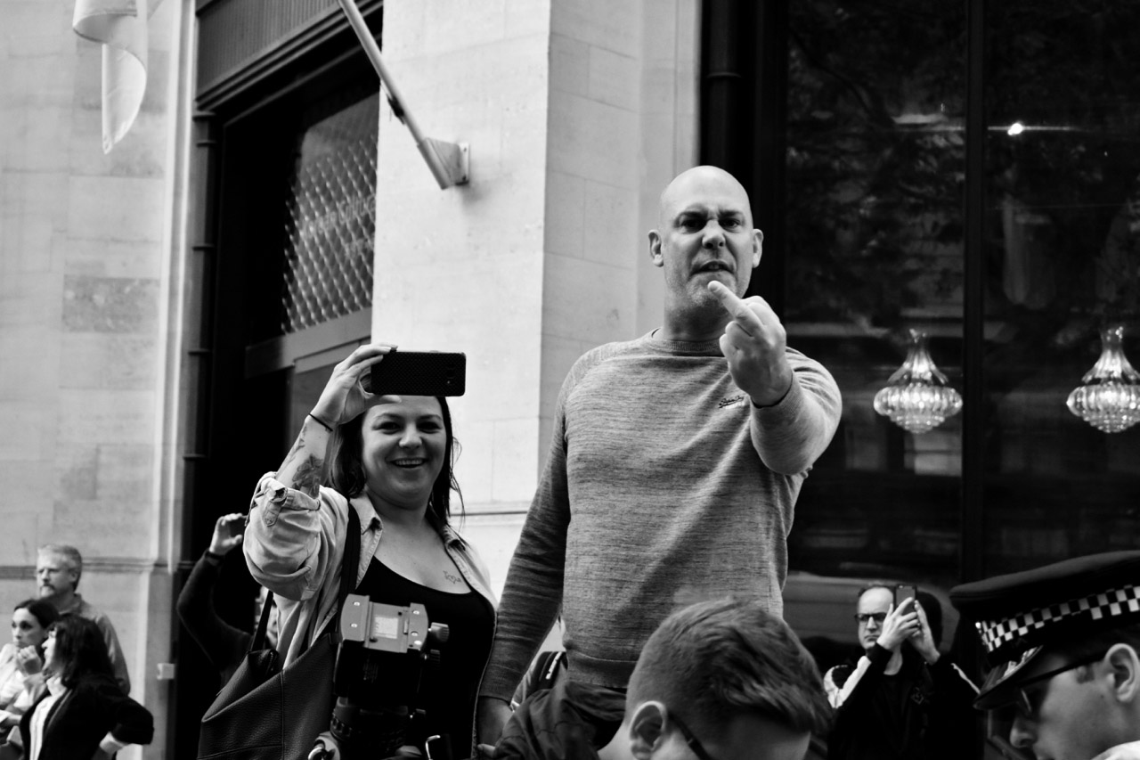 Protest man giving camera middle finger