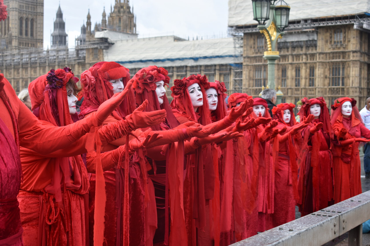 Protest women in red dresses and white face-paint