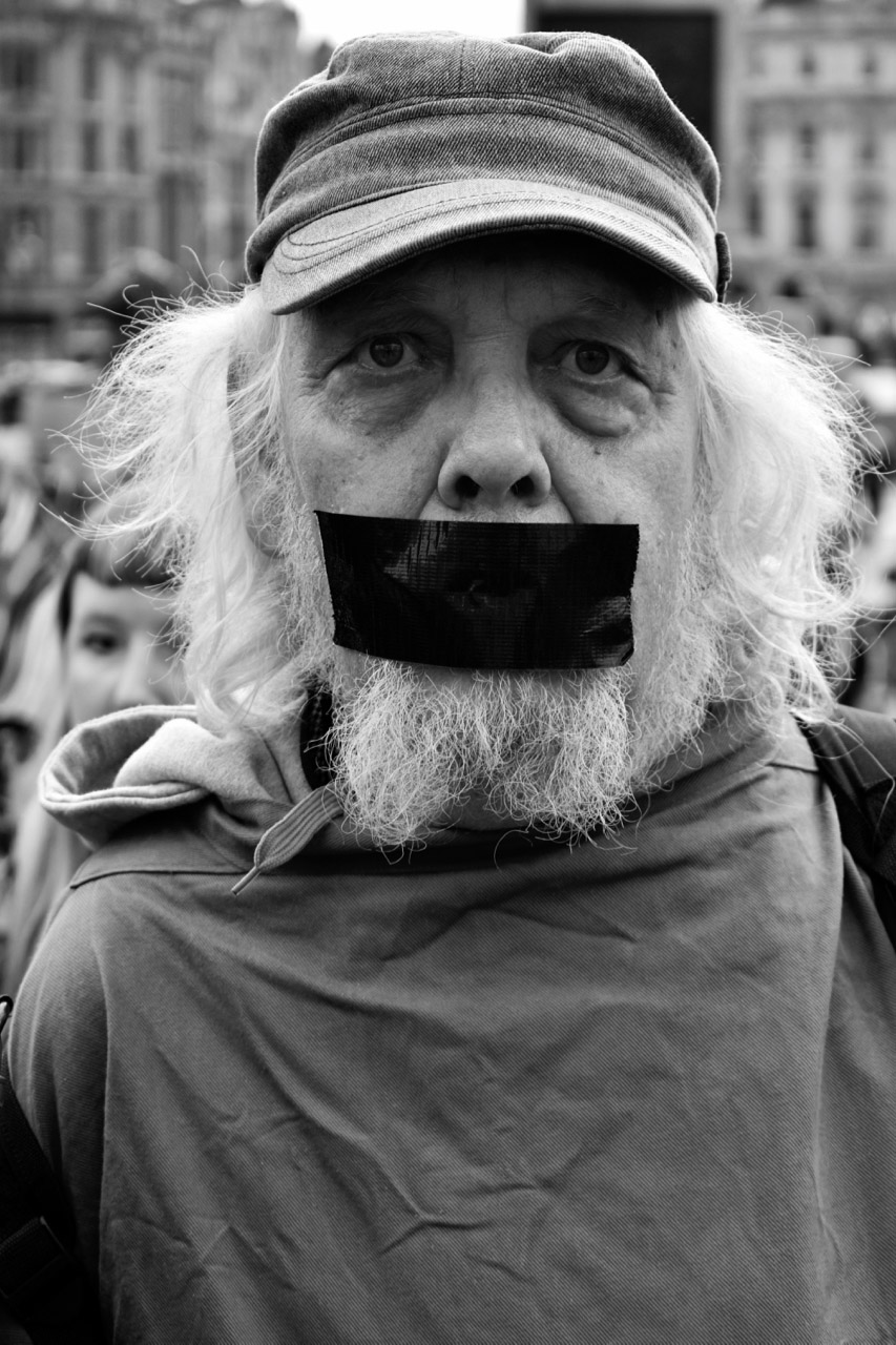 Protest man with black duct-tape over mouth