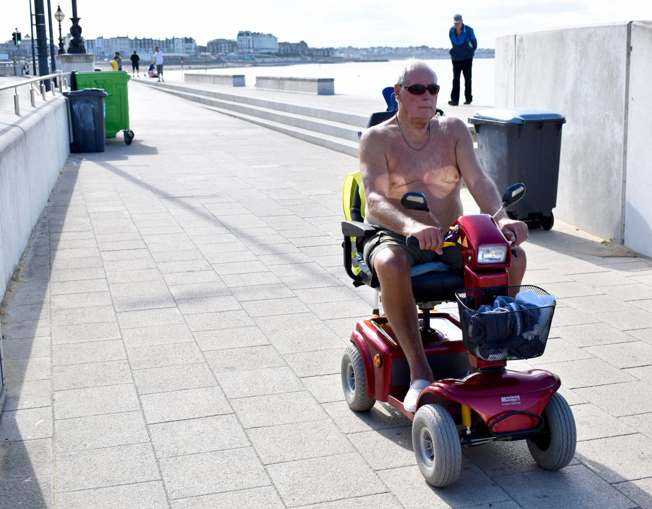 Image of man driving in mobility scooter.