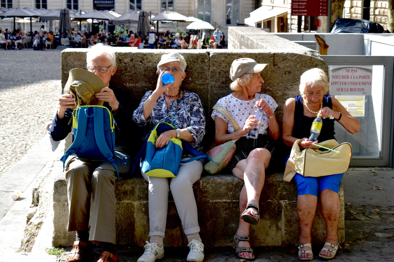 Image of four pensioners eating ice-cream at the seaside.